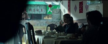 Movie still from “The Age of Adaline” (2015), directed by Lee Toland Krieger – A woman sitting at a table reading a book; Medium shot, Low angle