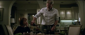 Movie still from “The Age of Adaline” (2015), directed by Lee Toland Krieger – An older man pouring a glass of wine for an older woman; Medium shot, Over the shoulder angle