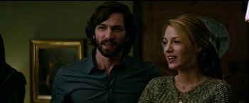 Movie still from “The Age of Adaline” (2015), directed by Lee Toland Krieger – A man and a woman standing next to each other in a room; Medium shot, Over the shoulder angle