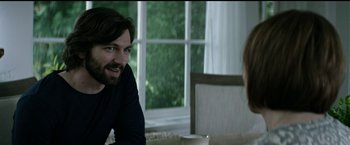 Movie still from “The Age of Adaline” (2015), directed by Lee Toland Krieger – A man and a woman sitting in front of a window; Medium shot, Over the shoulder angle