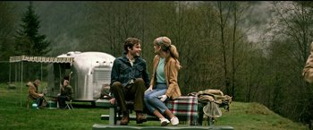 Movie still from “The Age of Adaline” (2015), directed by Lee Toland Krieger – A man and a woman sitting on top of a wooden bench; Medium shot, Over the shoulder angle
