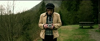Movie still from “The Age of Adaline” (2015), directed by Lee Toland Krieger – A man holding a camera while standing in a field; Medium shot, High angle