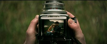 Movie still from “The Age of Adaline” (2015), directed by Lee Toland Krieger – A person taking a picture of a man and a woman; Extreme Close Up shot, High angle