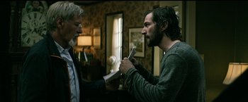 Movie still from “The Age of Adaline” (2015), directed by Lee Toland Krieger – Two men holding wii remotes in a living room; Medium shot, Over the shoulder angle
