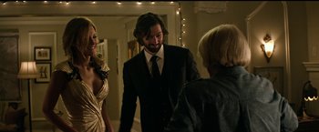 Movie still from “The Age of Adaline” (2015), directed by Lee Toland Krieger – A man in a suit standing next to two women; Medium shot, Over the shoulder angle