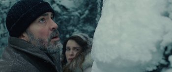 Movie still from “The American” (2010), directed by Anton Corbijn – A man and a woman in the snow looking at each other; Close Up shot, Over the shoulder angle