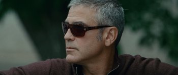 Movie still from “The American” (2010), directed by Anton Corbijn – A person wearing sunglasses; Close Up shot, Low angle