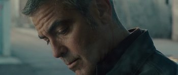 Movie still from “The American” (2010), directed by Anton Corbijn – A man's face as he looks to his left; Close Up shot, Low angle