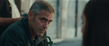 Movie still from “The American” (2010), directed by Anton Corbijn – A person wearing a jacket; Close Up shot, Over the shoulder angle