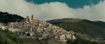 Movie still from “The American” (2010), directed by Anton Corbijn – A very old looking town on the side of a hill; Extreme Wide shot, Low angle