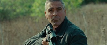 Movie still from “The American” (2010), directed by Anton Corbijn – A person holding a rifle; Close Up shot, Low angle