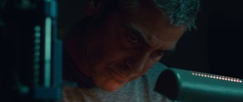 Movie still from “The American” (2010), directed by Anton Corbijn – A person looking at the camera; Close Up shot, Low angle