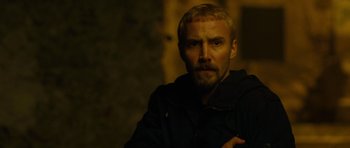 Movie still from “The American” (2010), directed by Anton Corbijn – A person wearing a black jacket; Close Up shot, Over the shoulder angle