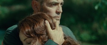 Movie still from “The American” (2010), directed by Anton Corbijn – A person holding another person's hair; Close Up shot, Low angle