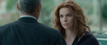 Movie still from “The American” (2010), directed by Anton Corbijn – A person standing next to another person; Close Up shot, Over the shoulder angle