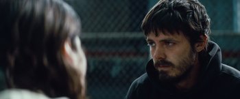 Movie still from “Out of the Furnace” (2013), directed by Scott Cooper – A person talking to another person; Close Up shot, Over the shoulder angle