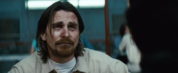 Movie still from “Out of the Furnace” (2013), directed by Scott Cooper – A person with long hair and a beard; Close Up shot, Over the shoulder angle