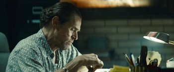 Movie still from “Out of the Furnace” (2013), directed by Scott Cooper – A person sitting at a table; Close Up shot, Over the shoulder angle