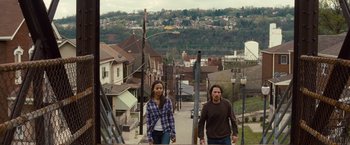 Movie still from “Out of the Furnace” (2013), directed by Scott Cooper – A man and a woman walking down a street; Extreme Wide shot, High angle