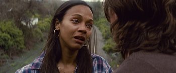 Movie still from “Out of the Furnace” (2013), directed by Scott Cooper – A young woman is talking to a young man outside; Close Up shot, Over the shoulder angle