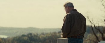 Movie still from “Out of the Furnace” (2013), directed by Scott Cooper – An older man standing on top of a hill looking at the sky; Medium shot, Low angle