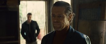 Movie still from “Out of the Furnace” (2013), directed by Scott Cooper – A person wearing a suit and tie; Close Up shot, Over the shoulder angle