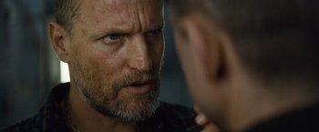 Movie still from “Out of the Furnace” (2013), directed by Scott Cooper – A person with a beard looking at another person; Close Up shot, Over the shoulder angle