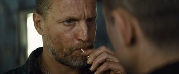 Movie still from “Out of the Furnace” (2013), directed by Scott Cooper – A person with a cigarette in his mouth; Close Up shot, Over the shoulder angle