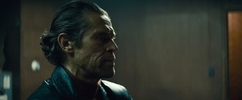 Movie still from “Out of the Furnace” (2013), directed by Scott Cooper – An older man is looking off into the distance; Close Up shot, Over the shoulder angle