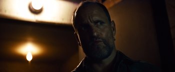 Movie still from “Out of the Furnace” (2013), directed by Scott Cooper – A person with a beard looking at the camera; Close Up shot, Low angle