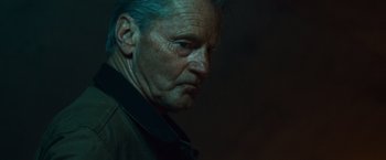 Movie still from “Out of the Furnace” (2013), directed by Scott Cooper – An older man with a blue hair streak on his head; Close Up shot, Low angle