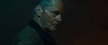 Movie still from “Out of the Furnace” (2013), directed by Scott Cooper – An older man with blue hair stares into the distance; Close Up shot, Low angle