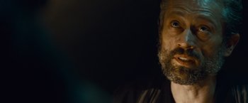 Movie still from “Out of the Furnace” (2013), directed by Scott Cooper – A person with a beard; Close Up shot, Over the shoulder angle