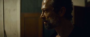 Movie still from “Out of the Furnace” (2013), directed by Scott Cooper – A person with a beard; Close Up shot, Over the shoulder angle