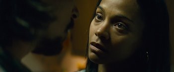 Movie still from “Out of the Furnace” (2013), directed by Scott Cooper – A woman's face and a man's face in the background; Close Up shot, Over the shoulder angle