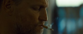 Movie still from “Out of the Furnace” (2013), directed by Scott Cooper – A person with a cigarette in his mouth; Extreme Close Up shot, Over the shoulder angle