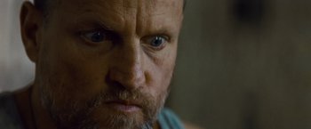 Movie still from “Out of the Furnace” (2013), directed by Scott Cooper – A man with a beard and blue eyes; Close Up shot, Low angle