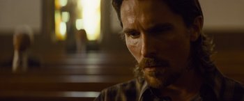 Movie still from “Out of the Furnace” (2013), directed by Scott Cooper – A person with a beard; Close Up shot, Low angle