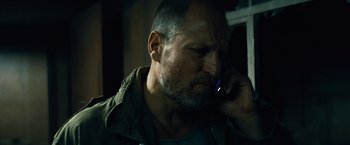 Movie still from “Out of the Furnace” (2013), directed by Scott Cooper – A person talking on a cell phone; Close Up shot, Low angle