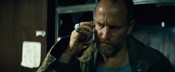 Movie still from “Out of the Furnace” (2013), directed by Scott Cooper – A person talking on a cell phone; Close Up shot, Low angle