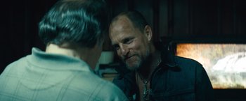 Movie still from “Out of the Furnace” (2013), directed by Scott Cooper – A man with a beard is looking at another man's reflection in a mirror; Close Up shot, Over the shoulder angle