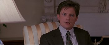 Movie still from “The American President” (1995), directed by Rob Reiner – A person wearing a suit and tie; Close Up shot, Over the shoulder angle