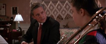 Movie still from “The American President” (1995), directed by Rob Reiner – A man wearing a suit and tie talking to a woman; Close Up shot, Over the shoulder angle