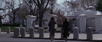Movie still from “The American President” (1995), directed by Rob Reiner – Two women walking down the street in front of a building; Wide shot, Low angle