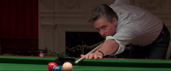 Movie still from “The American President” (1995), directed by Rob Reiner – A man is playing a game of pool on a pool table; Medium shot, Over the shoulder angle