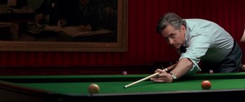 Movie still from “The American President” (1995), directed by Rob Reiner – A man is playing a game of pool on a pool table; Medium shot, High angle