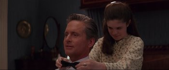 Movie still from “The American President” (1995), directed by Rob Reiner – A woman helping a man put on a bow tie; Close Up shot, Over the shoulder angle