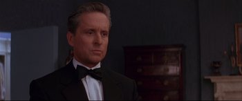 Movie still from “The American President” (1995), directed by Rob Reiner – A person wearing a suit and a bow tie; Close Up shot, Over the shoulder angle