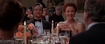 Movie still from “The American President” (1995), directed by Rob Reiner – A man and a woman sitting at a dinner table; Medium shot, Low angle