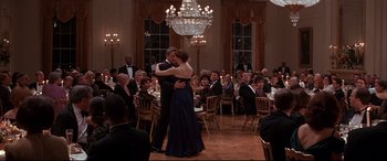 Movie still from “The American President” (1995), directed by Rob Reiner – A man and a woman dancing in front of a group of diners; Wide shot, Low angle